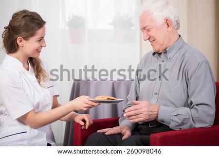 Care assistant and retired man at home