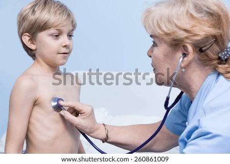 Sick little cute boy taking a deep breath during examination