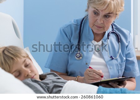Experienced female doctor prescribing the medication for sick little kid