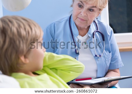 Caring pediatrician checking little boy\'s health condition