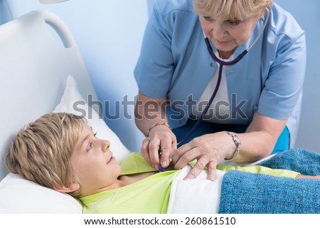 Litle ill boy on his examination in hospital bed