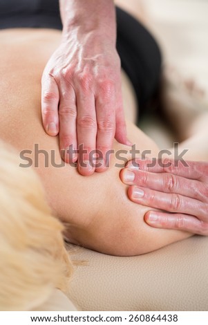 Close-up of physiotherapist treating soft tissues of young woman