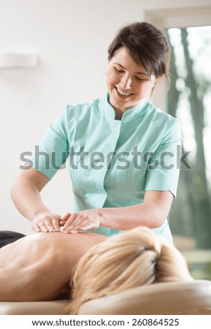 Young blonde woman relaxing during back massage