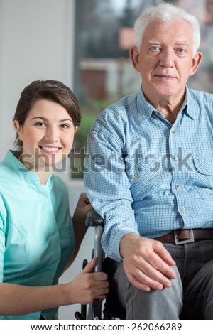 Image of disabled man and social welfare worker