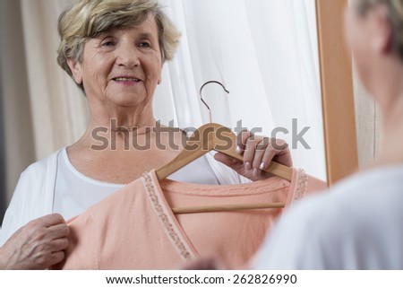 Happy elder lady preparing for important meeting