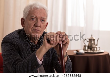 Portrait of sad old businessman suffering from loneliness