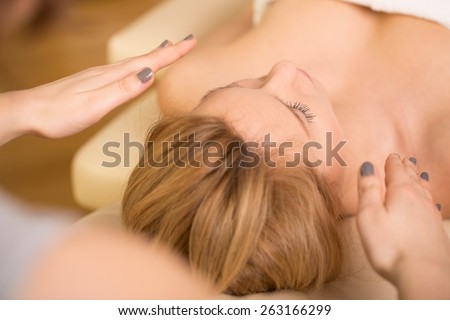 Beauty blonde woman relaxing during reiki healing