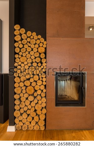 Cosy interior closeup with fireplace and wood storage space