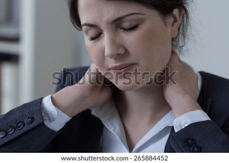 Female white-collar worker having neck pain