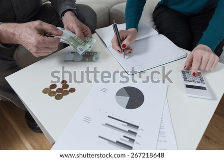 Couple having financial problems and analyzing family budget