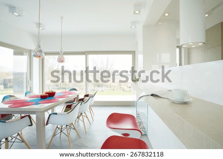 White table with colorful setting in spacious bright dining hall