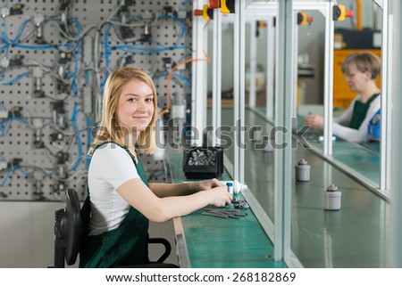 Young female production worker in manufacturing plant