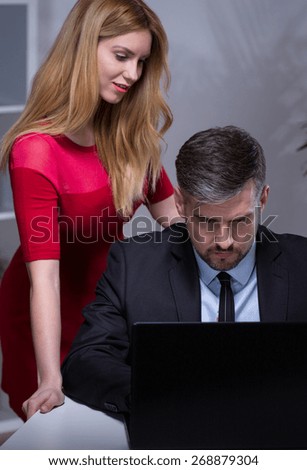 Young beautiful secretary talking with her handsome boss