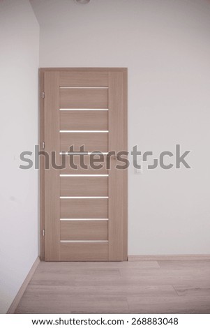 Empty corridor and closed bedroom door