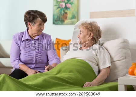 Woman visiting her sick elderly friend