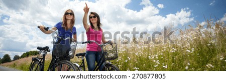 Girls on a bicycle trip in the country