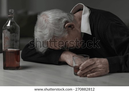 Senior man sleeping after drinking too much alcohol