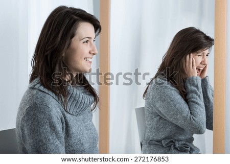 Picture presenting scared woman simulating good mood