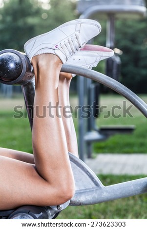 Muscular female calves during the gym workout