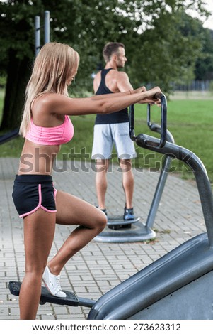 Athletes exercising in the outdoor gym in park