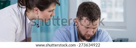 Tired and worried physicians at doctor\'s office - panorama