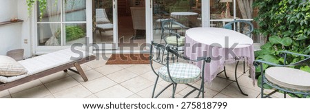 Elegant veranda with designed garden furniture an ivy - panorama