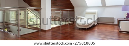 Panoramic view of beige chair in an attic