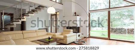 Panorama of stylish living room with big window