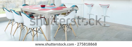 Modern dining table in interior with color elements