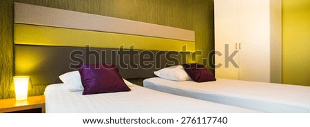 Bedroom with color elements in evening light, panorama