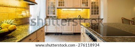 Panorama of granitic countertop in luxury kitchen