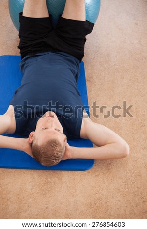Man working out on the exercise floor mat
