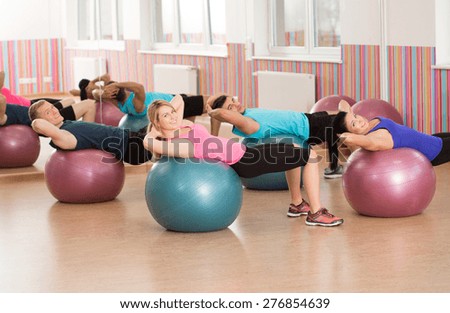 Exercise with swiss ball during fitness classes
