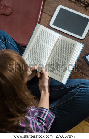 View from the top of woman reading book