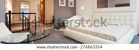 White modern bedroom with mirror in apartment, panorama
