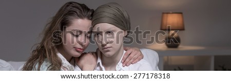 Horizontal view of friend supporting cancer woman
