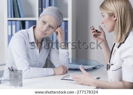 Young businesswoman with cancer in doctor\'s office