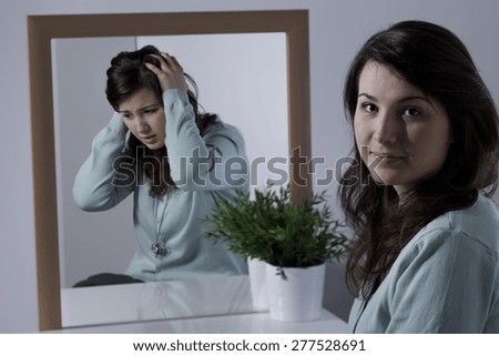 Young woman with depression hiding her emotions