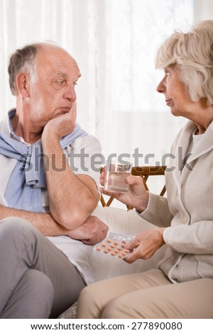 Elder woman asking husband about taking medicines