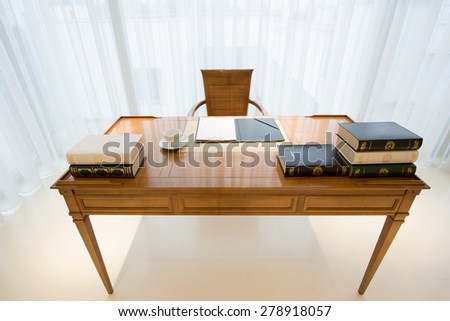 Wooden vintage style desk with elegant books