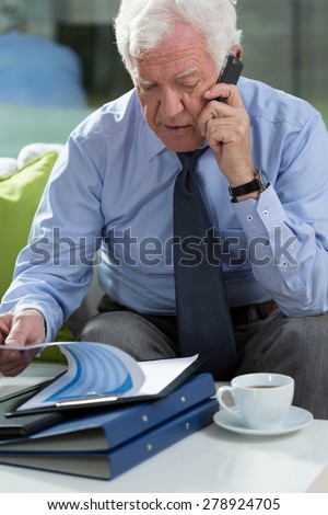 View of elder businessman talking on phone