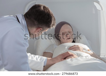 Worried doctor caring about young cancer woman