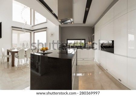 Big modern kitchen connected with spacious dining hall