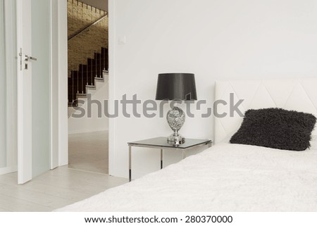 White entrance door to simple exclusive bedroom