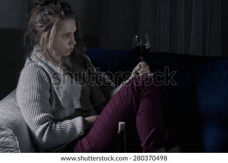 Abandoned despair woman drinking red wine alone