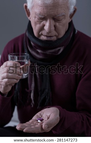 Elderly man with infection taking medicine