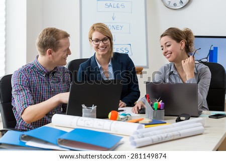Office employees talking and laughing during work