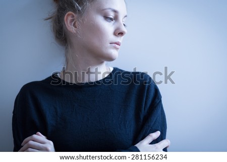Portrait of sad woman in black sweater