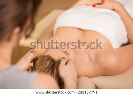 Young pretty woman during her holistic treatment