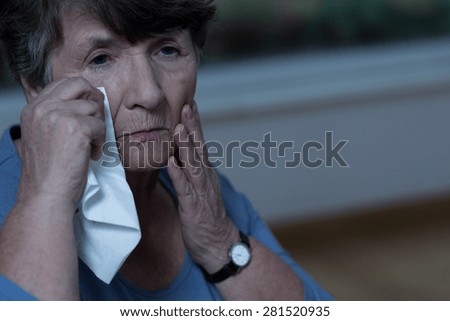Old devastated women in mourning is crying